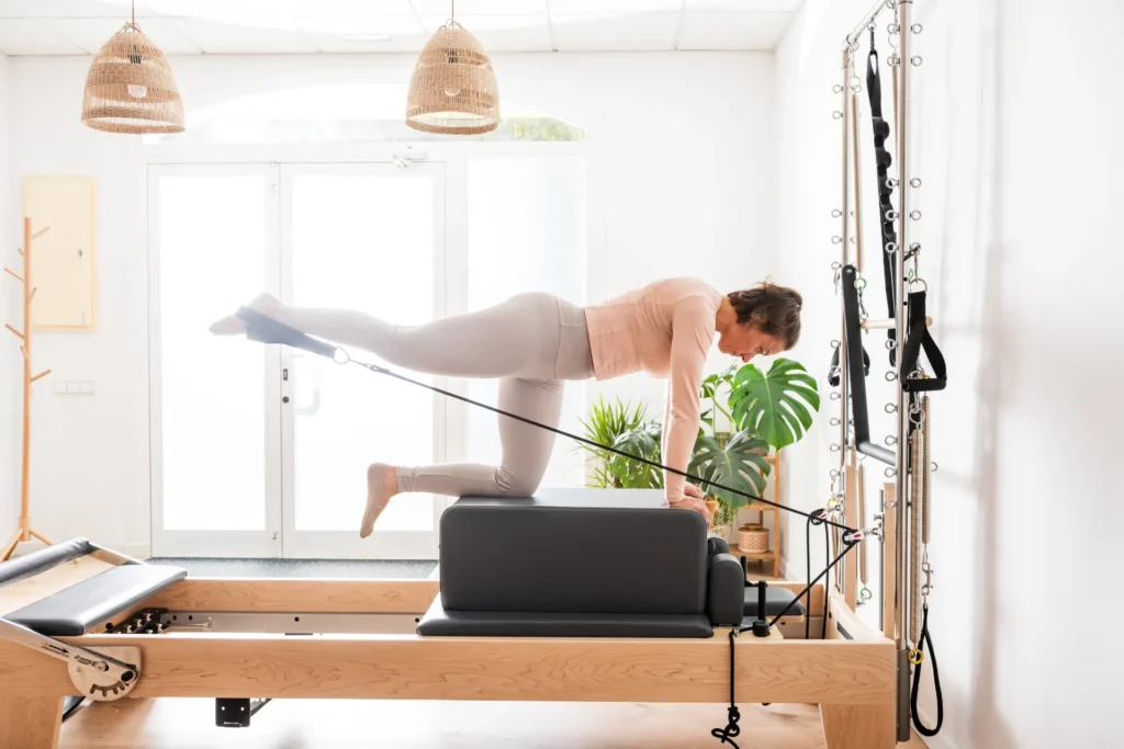 woman exercising with pilates reformer and leg pul 2026 03 25 05 09 43 utc