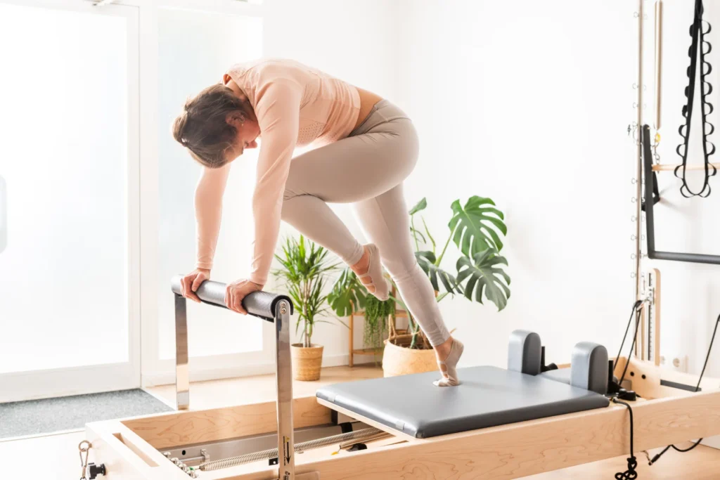 woman practicing pilates exercise on reformer in s 2026 03 25 09 41 58 utc