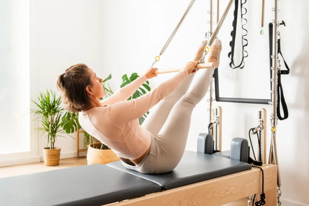 woman practicing pilates using reformer bed in gym 2026 03 25 09 47 12 utc