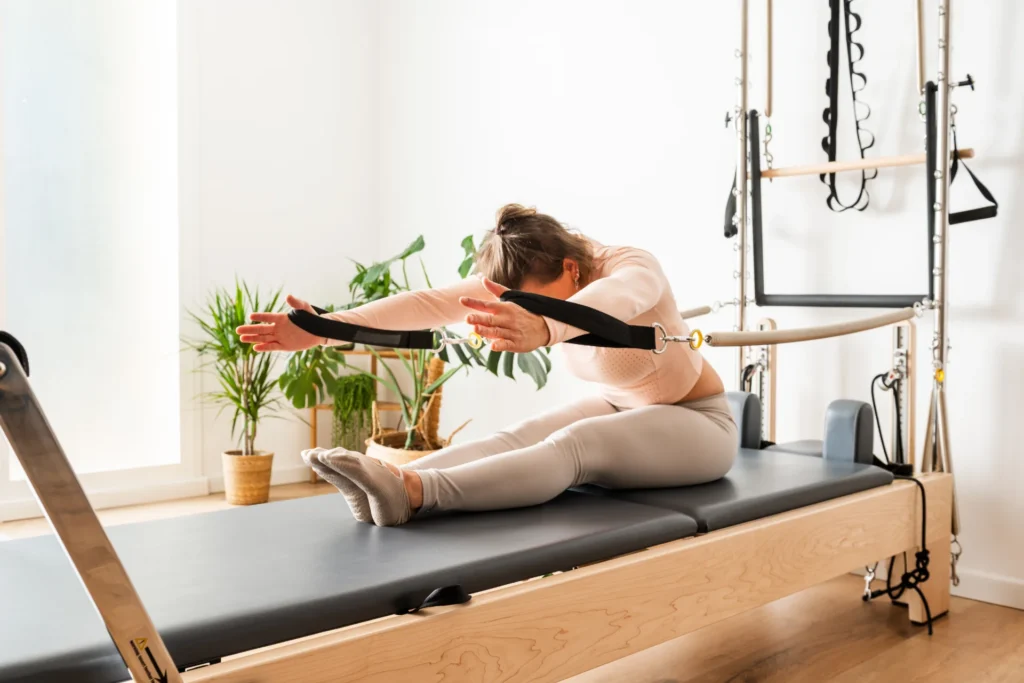 young woman practicing pilates using reformer bed 2026 01 09 10 59 00 utc
