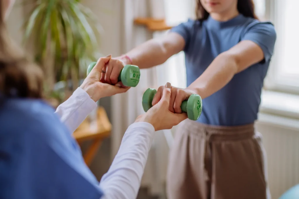 teen doing arm exercises with help indoors 2026 01 05 06 21 28 utc